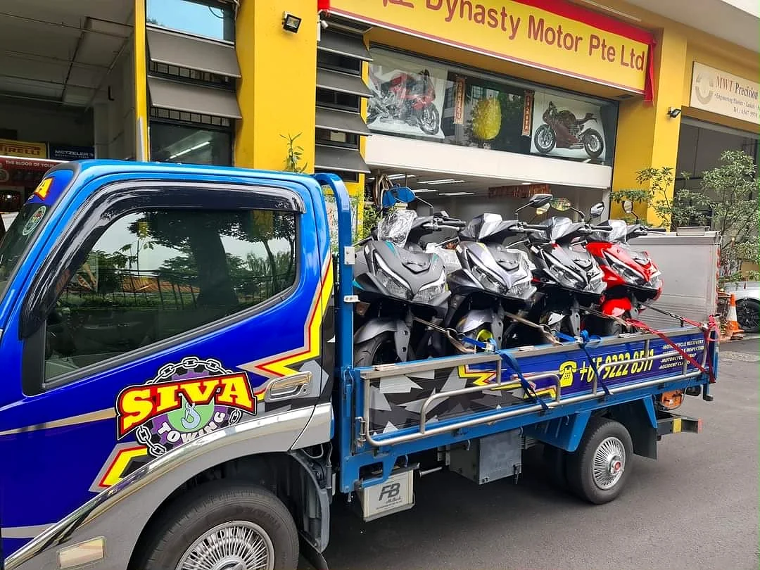 Siva Towing lorry collecting motorcycles at a workshop